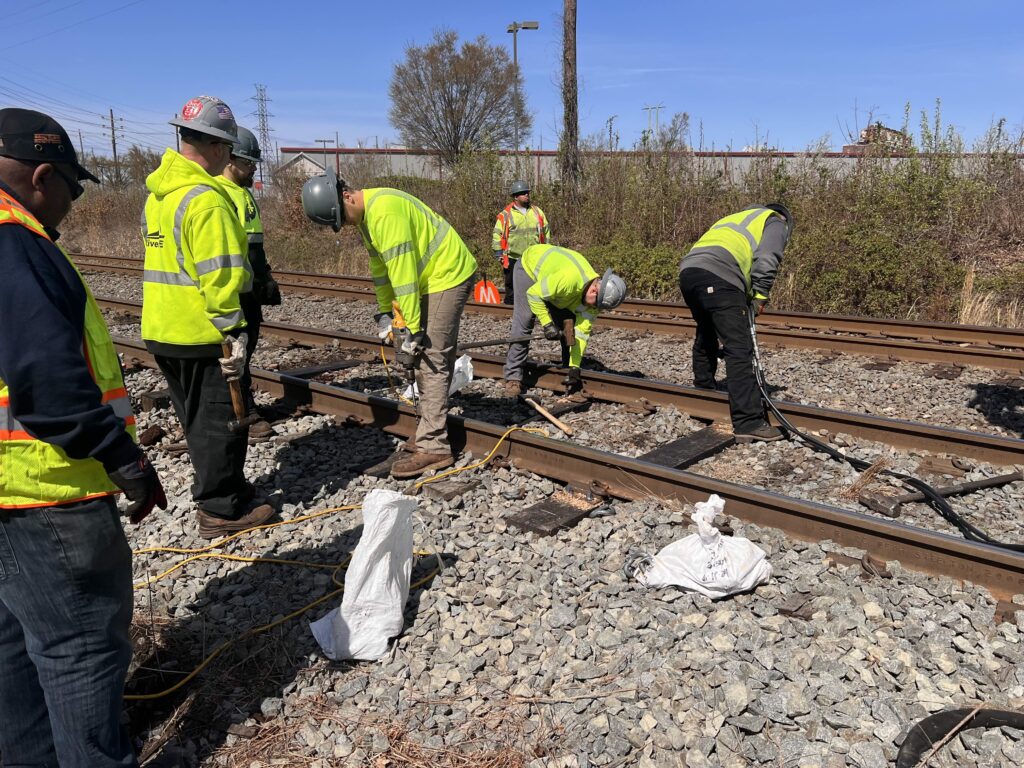 Workers repairing light rail track