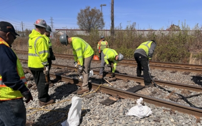 Workers repairing light rail track